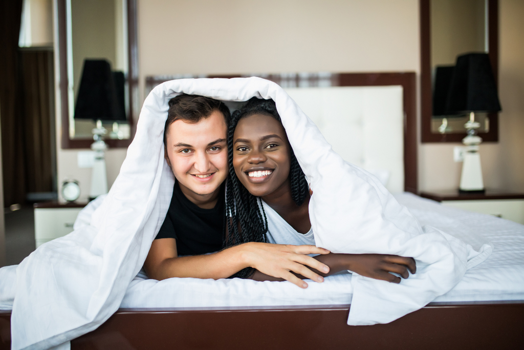 couple in bed to having  to choose coverlet vs quilts
